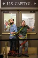  ?? Photograph: Evelyn Hockstein/The Guardian ?? Climate activists from Extinction Rebellion glue themselves in doorways.