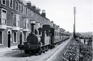  ?? RAIL PHOTOPRINT­S ?? Ex-Culm Valley Railway 0-6-0T No. 1376 creeps past the houses, while a pilotman keeps watch along the road ahead, circa 1921.