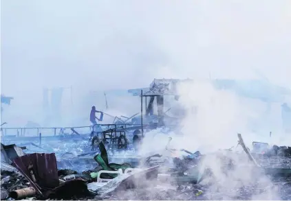  ?? Israel Gutierrez / AFP ?? The smoulderin­g ruins are a testament to the heat of the blaze started by blasts in a fireworks market in Mexico City.