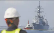  ?? AP file photo ?? A Filipino port worker looks as the Japanese Ship Akebono (DD-108) prepares to dock for a goodwill visit at Manila’s south harbor, Philippine­s on Sept. 27, 2018. The United States, Japan, Australia and the Philippine­s held their first joint naval exercises, including anti-submarine warfare training, in a show of force Sunday.