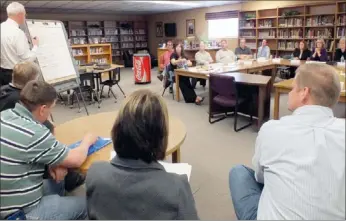  ?? Times photograph by Annette Beard ?? School Board and community members listened to Dr. Paul Hewitt, advisor to the board, present the strengths and weaknesses of superinten­dent candidates Saturday in the high school media center after Smith listed the qualities as perceived by the...