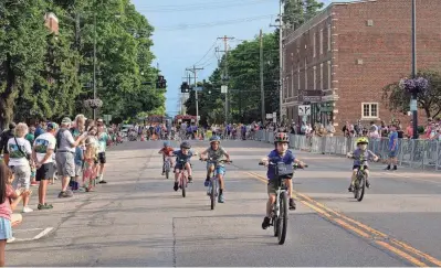  ?? ?? Young riders get their time to shine during the kids’ sprints on Grandview Avenue during the Tour de Grandview Cycling Classic on June 10.