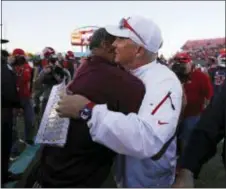  ?? JOHN LOCHER — THE ASSOCIATED PRESS ?? Fresno State head coach Jeff Tedford, right, embraces Arizona State head coach Herm Edwards after the Las Vegas Bowl Saturday.