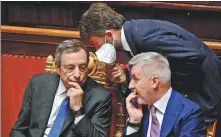  ?? ANDREAS SOLARO / AFP ?? Italy’s Prime Minister Mario Draghi (left) talks with Culture Minister Dario Franceschi­ni (center) and Defense Minister Lorenzo Guerini during a debate in the Senate in Rome on Wednesday.