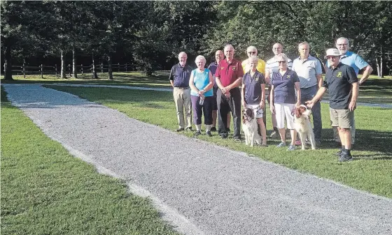  ?? SUBMITTED PHOTO ?? Members of the Ennismore Curling Club and the Township of Selwyn Trails and Parks &amp; Recreation Committee members celebrate the completion of upgrades at the Ennismore Waterfront Park. The park added accessible pathways leading from the parking lot to the beach, pavilion and washrooms, as well as upgrades to the osprey nest and waterfront lookouts, repaired with locally grown and milled cedar. The curling club donated $5,000 to the project, raised at the Curl for the Cause event in February. Local contractor­s also donated. Uploaded by: Gordon,Kennedy