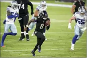  ?? NICK WASS — THE ASSOCIATED PRESS ?? Ravens quarterbac­k Lamar Jackson (8) runs for a touchdown on a keeper against the Cowboys on Tuesday in Baltimore.