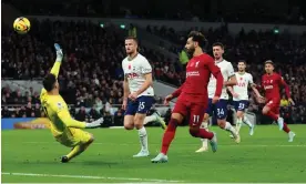  ?? Advantage. Photograph: Marc Atkins/Getty Images ?? Mohamed Salah deftly lifts the ball over Hugo Lloris for his second goal to double Liverpool’s