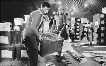  ?? — Reuters photo ?? Afghan election commission workers prepare ballot boxes and election material to send to the polling stations at a warehouse in Kabul.