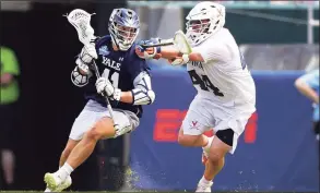  ?? Drew Hallowell / Getty Images ?? Yale’s Matt Brandau, left, tries to get past Virginia’s Logan Greco during the NCAA championsh­ip game on May 27, 2019.