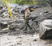  ??  ?? SANTA BARBARA County Sheriff Jeff Farmer surveys a f looddamage­d area in Montecito in March, two months after the slide.