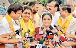 ?? — DC ?? Nandamuri Balakrishn­a and Nandamuri Suhasini share a lighter moment while Balakrishn­a’s sister Lokeshwari speaks to the media at NTR Ghat on Saturday.