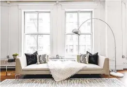  ?? COURTESY PHOTO ?? All neutral upholstery creates an opportunit­y for contrast elements such as black. A chocolate brown or a charcoal gray can also stand out amid the white.