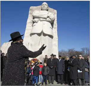  ?? (AP/Jose Luis Magana) ?? Clifton Ross directs a choir Monday at the Martin Luther King Jr. Memorial during the ninth annual Wreath Laying and Day of Reflection and Reconcilia­tion in Washington. More photos at arkansason­line.com/121mlkday/.