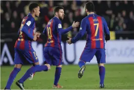  ?? — AP ?? VILLARREAL: FC Barcelona’s Lionel Messi, center, celebrates after scoring with teammate Arda Dura, right, during the Spanish La Liga soccer match between Villarreal and Barcelona at the Ceramica stadium in Villarreal, Spain, Sunday.