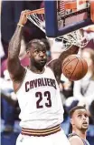  ?? Jason Miller / Getty Images ?? Stephen Curry watches helplessly as LeBron James dunks during a Game 3 rout in which James had 32 points.