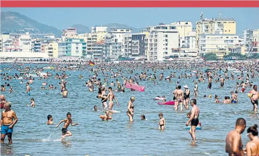  ?? GENT SHKULLAKU AFP/GETTY IMAGES ?? A crowded beach of the Adriatic Sea in the city of Durres, as an August heatwave sweeps across Europe.