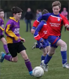  ??  ?? Wexford Albion goalscorer Callum Fowler posing a threat as Curracloe United defender Rian Ormonde tries to halt his run,