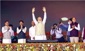  ?? — PTI ?? Prime Minister Narendra Modi waves to the crowd during a public rally in Shimla on Tuesday. Himachal Pradesh Chief Minister Jai Ram Thakur and Union minister Anurag Thakur are also seen.