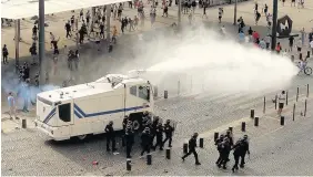  ?? NIALL CARSON/PA WIRE ?? Police fire water cannons to control the fighting after football fans clashed ahead of the England v Russia France Euro 2016 match