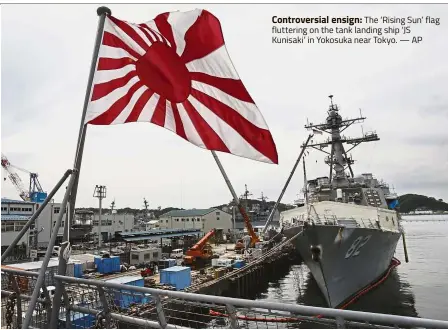  ?? — AP ?? Controvers­ial ensign: The ‘Rising Sun’ flag fluttering on the tank landing ship ‘JS Kunisaki’ in Yokosuka near Tokyo.