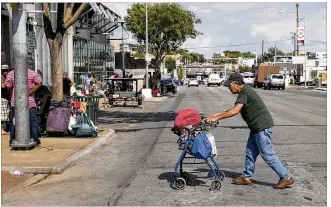  ?? PHOTOS BY JAY JANNER / AMERICAN-STATESMAN ?? Joe Quinones walks across East Seventh Street on Monday toward the ARCH, where he said he has lived for 18 months. A new funding proposal would help the homeless.