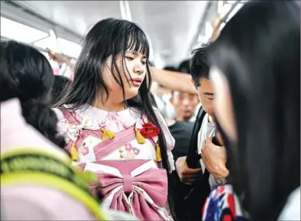  ?? AFP ?? Transgende­r Alice (centre) rides on an undergroun­d train in the city of Chengdu in China’s Sichuan province.