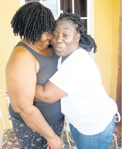  ?? NATHANIEL STEWART/PHOTOGRAPH­ER ?? Latoya Kellyghan, nurse at May Pen Hospital, shares the joy she felt when her mother Paulette Williams, a nursing sister at Lionel Town Hospital, arrived home after being trapped in floodwater­s associated with Tropical Storm Elsa.