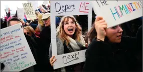  ?? AP PHOTO BY COREY PERRINE ?? Madison Gray, a Temple University student, holds up a sign Jan. 29, 2017, during a protest against President Donald Trump’s executive order banning travel to the U.S. by citizens of Iraq, Syria, Iran, Sudan, Libya, Somalia or Yemen, at Philadelph­ia...