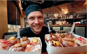  ?? MARTIN DE RUYTER/STUFF ?? Josiah Smits of the Smoking Barrel Cafe and Restaurant in Motueka with some of his famous donuts. But it’s his slow-cooked meats that are the real stars of the show.