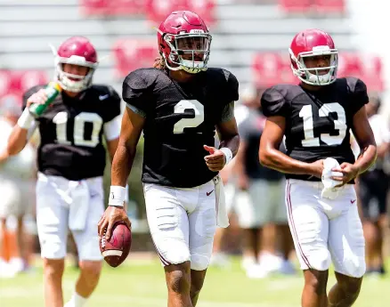  ?? Associated Press ?? n Alabama quarterbac­k Jalen Hurts, center, leads the way to the next drill during Alabama’s fall camp Aug. 19 at Bryant-Denny Stadium in Tuscaloosa, Ala. For all the resilience and talent Hurts flashed last season, late-season passing struggles...
