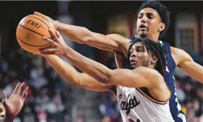  ?? CHARLES KRUPA/AP ?? Boston College forward Devin McGlockton, front, battles Virginia guard Ryan Dunn for a rebound during Wednesday night’s game.