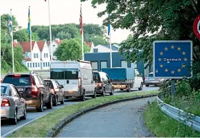  ?? AP ?? Vehicles queue at the border crossing in Krusaa, Denmark, after Denmark reopened its borders to Germany on June 15.