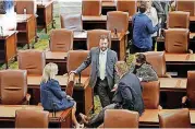  ??  ?? A few lawmakers linger on the floor of the House chamber Monday after returning to the state Capitol for the first day of the second special session called by Gov. Mary Fallin to address budget woes.