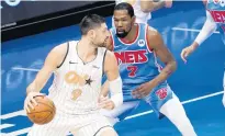  ?? MARY ALTAFFER | AP ?? Orlando Magic center Nikola Vucevic (9) drives against Brooklyn Nets forward Kevin Durant (7) Saturday.