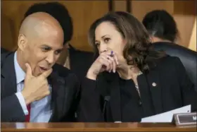  ?? J. SCOTT APPLEWHITE — THE ASSOCIATED PRESS ?? In this photo, Sen. Cory Booker, D-N.J., left, and Sen. Kamala Harris, D-Calif., confer before questionin­g Supreme Court nominee Brett Kavanaugh as he testifies before the Senate Judiciary Committee on the third day of his confirmati­on hearing, on Capitol Hill in Washington. Spurred on by the left, Democrats brought fire and fury to the confirmati­on hearings for President Donald Trump’s Supreme Court nominee, but their aggressive tactics have put at least one senator at risk of an ethics investigat­ion.