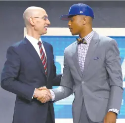  ?? AFP PHOTO ?? Markelle Fultz walks on stage with NBA commission­er Adam Silver after being drafted first overall by the Philadelph­ia 76ers during the first round of the 2017 NBA Draft at Barclays Center on Friday in New York City.