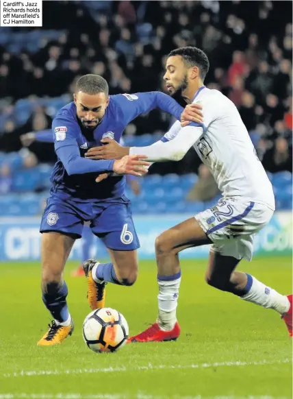  ??  ?? Cardiff’s Jazz Richards holds off Mansfield’s CJ Hamilton