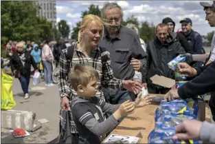  ?? AP photo ?? People queue to receive food donations in Kharkiv, eastern Ukraine on Thursday.