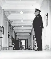  ?? [OKLAHOMAN ARCHIVE PHOTO] ?? Guard J.D. Trasclair keeps watch in a deserted corridor at the capitol in 1970.