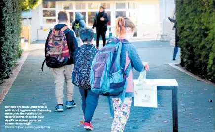  ?? Photos / Bevan Conley; Alex Burton ?? Schools are back under level 2 with strict hygiene and distancing measures; the retail sector describes the hit it took over April’s lockdown period as economic carnage.