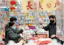  ?? JONATHAN HAYWARD THE CANADIAN PRESS ?? People shop in Vancouver’s Chinatown. Chinese-canadian folks and businesses are facing racism in the pandemic, leaders say.