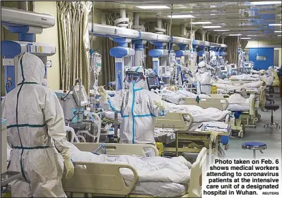  ?? REUTERS ?? Photo taken on Feb. 6 shows medical workers attending to coronaviru­s patients at the intensive care unit of a designated hospital in Wuhan.