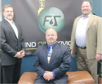  ??  ?? W. George Conroy, the founder and chief executive of Find Oil Services, is flanked by chief informatio­n officer Jim Teetzel, left, and sales manager Brad Gathercole.