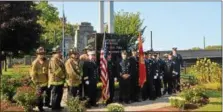  ??  ?? Members of the Troy fire and police department­s pose for a group photo at the city’s 9- 11memorial after a ceremony Monday to mark the 16th anniversar­y of the terror attacks of Sept. 11, 2001.