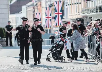  ?? JACK TAYLOR GETTY IMAGES ?? Police officers patrol ahead of a dress rehearsal of the wedding of Prince Harry and Meghan Markle outside Windsor Castle.