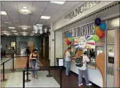  ??  ?? Left to right, Butte College student Sadie Neff waits as Tawab Rahmati and Carlos Jimenez speak with financial aid advisors on the first day of school in Oroville.