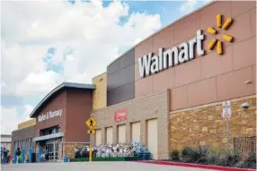  ?? ASSOCIATED PRESS FILE PHOTO ?? People walk in and out of a Walmart store in Dallas. Walmart announced new moves Monday to speed up the return process for online purchases, including letting some shoppers keep the stuff they don’t want and still get a refund.