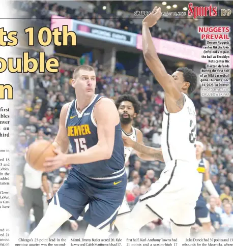  ?? PHOTO BY DAVID ZALUBOWSKI/AP ?? NUGGETS PREVAIL Denver Nuggets center Nikola Jokic (left) looks to pass the ball as Brooklyn Nets center Nic Claxton defends during the first half of an NBA basketball game Thursday, Dec. 14, 2023, in Denver.