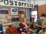  ??  ?? Joy Mein runs the U. S. post office at RainbowOrc­hard’s farm retail store in Halfmoon.