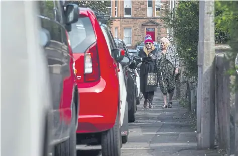  ?? ?? The ban on pavement parking, introduced in January, has led to an increase in complaints about the state of Edinburgh’s footpaths